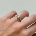 bague-fiancailles-halo-moissanite-1-5ct-taille-brillant-sur-doigt-gros-plan-or-jaune-heaven-hariets.jpg